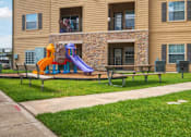 Thumbnail 10 of 34 - A playground with a slide at Stonehaven Apartments in Houston, TX