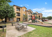 Thumbnail 9 of 34 - Playground with picnic area and grills at Stonehaven Apartments in Houston, TX