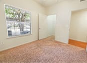 Thumbnail 30 of 34 - Bedroom with a large window and plush carpeting at  Stonehaven Apartments in Houston, TX