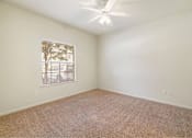 Thumbnail 25 of 34 - Bright bedroom with a ceiling fan at Stonehaven Apartments in Houston, TX