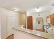Thumbnail 22 of 34 - Kitchen with a breakfast bar at Stonehaven Apartments in Houston, TX