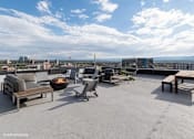 Thumbnail 22 of 50 - Rooftop patio with a fire pit and seating area at Archer Tower in Denver, CO