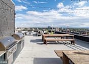 Thumbnail 23 of 50 - BBQ grills on the rooftop deck at Archer Tower in Denver, CO