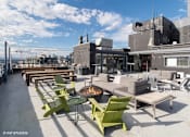 Thumbnail 21 of 50 - Rooftop patio with a fire pit and seating area at Archer Tower in Denver, CO