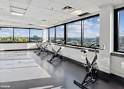 Thumbnail 33 of 50 - Exercise bikes with a stunning view in the fitness center at Archer Tower in Denver, CO