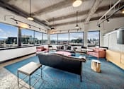 Thumbnail 38 of 50 - Penthouse entertainment lounge with comfortable seating at Archer Tower in Denver, CO