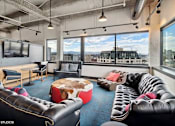 Thumbnail 36 of 50 - Penthouse entertainment lounge with comfortable seating at Archer Tower in Denver, CO