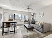 Thumbnail 9 of 50 - Cozy living room with a ceiling fan at Archer Tower in Denver, CO