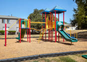 Thumbnail 17 of 20 - a playground with a swing set and slides