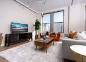 Thumbnail 4 of 19 - a living room with a couch and a tv