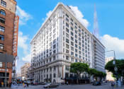 Thumbnail 19 of 19 - a large white building on the corner of a city street