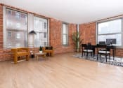 Thumbnail 8 of 19 - a living room with a piano and a brick wall