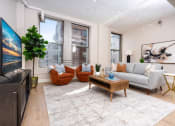 Thumbnail 1 of 19 - a living room with a couch and a tv