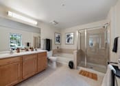 Thumbnail 22 of 42 - A bathroom with a walk-in shower and a toilet.
