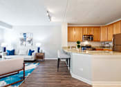 Thumbnail 24 of 42 - A kitchen with a white counter and wooden cabinets.
