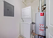 Thumbnail 32 of 42 - A white washing machine and dryer in a small room.