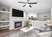 Thumbnail 2 of 32 - Renovated living area with a fireplace and ceiling fan at The Crossings at Russett in Laurel, MD