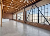 Thumbnail 16 of 57 - A large, empty room with a high ceiling and large windows.