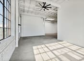 Thumbnail 22 of 57 - A room with a white ceiling and a fan.