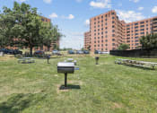 Thumbnail 18 of 30 - a city park with buildings in the background and a mailbox