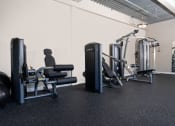 Thumbnail 14 of 16 - a gym with weights and other equipment in a room with white walls