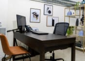 Thumbnail 6 of 16 - a desk with a computer and a phone in an office