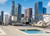 Thumbnail 10 of 16 - a rooftop pool with a city skyline in the background