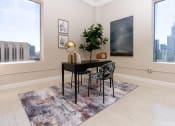 Thumbnail 5 of 16 - a dining room with a table and chairs and a large window
