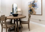 Thumbnail 4 of 16 - a dining room with a table and chairs