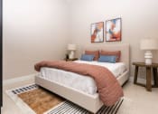 Thumbnail 7 of 16 - a bedroom with a bed and two paintings on the wall