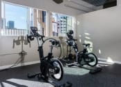 Thumbnail 13 of 16 - three exercise bikes in a room next to a window