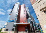 Thumbnail 9 of 32 - a tall building with a blue sky in the background