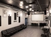 Thumbnail 11 of 17 - a large room with couches and a projection screen