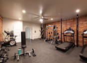 Thumbnail 3 of 17 - a home gym with a brick wall and exercise equipment