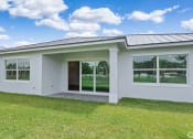 Thumbnail 9 of 37 - the front of a white house with windows and a lawn