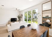 Thumbnail 16 of 31 - A modern dining room with a wooden table and chairs.