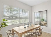 Thumbnail 37 of 37 - a dining room with a table and chairs and a large window