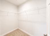 Thumbnail 27 of 31 - A room with white walls and a carpeted floor.