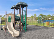 Thumbnail 31 of 37 - a playground with a slide and climbing equipment in a park