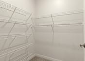 Thumbnail 19 of 44 - Empty white shelves in a room at Sonder Point 50+ Apartments, Brooklyn Center, MN, 55430