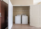 Thumbnail 25 of 44 - a washer and dryer in the laundry room of a manufactured home at The Winslow 62+ Apartments, West St Paul, MN