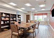 Thumbnail 28 of 44 - A dining room with a table and chairs at Sonder Point 50+ Apartments, Brooklyn Center, MN