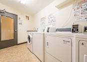 Thumbnail 24 of 32 - a laundry room with washers and dryers at Heritage Hills Apartments, Minnesota, 55437