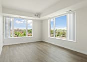 Thumbnail 8 of 44 - A room with a view of the outdoors through large windows at Sonder Point 50+ Apartments, Brooklyn Center, Minnesota