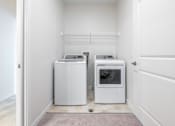 Thumbnail 23 of 44 - a washer and dryer in a laundry room at Sonder Point 50+ Apartments, Minnesota