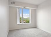 Thumbnail 14 of 44 - A room with a window overlooking a residential area at Sonder Point 50+ Apartments, Brooklyn Center, MN