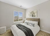 Thumbnail 21 of 23 - A bedroom with a large bed and a window with blinds.