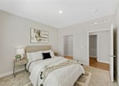 Thumbnail 20 of 23 - A bedroom with a large bed and a painting on the wall.