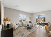 Thumbnail 2 of 12 - a living room with couches and chairs and a table and a balcony at Agave House Apartments, Casa Grande, 85122