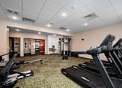 Thumbnail 30 of 40 - A gym with treadmills and exercise equipment.at Decatur Landing I & II, Brooklyn Park, MN